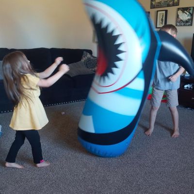 kids play with inflatable punching bag